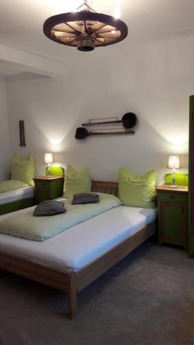 a bedroom with two beds and a chandelier at Casa Mosului - Transfăgărășan Bed & Breakfast in Cîrţişoara