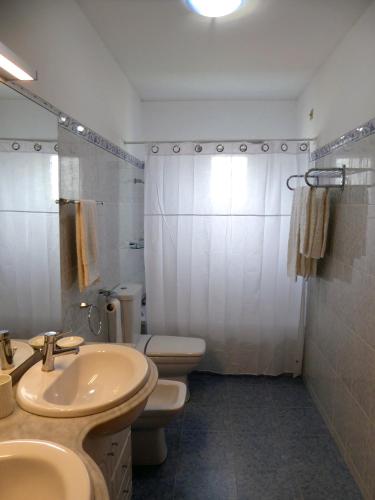 a bathroom with a sink and a toilet and a shower at Near Beach Apartment in Póvoa de Varzim