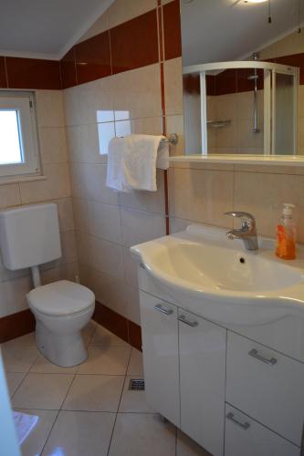 a bathroom with a sink and a toilet at Apartments Villa Lili in Tučepi