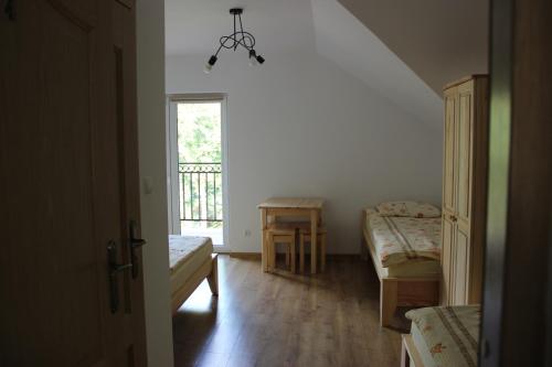 a small room with a bed and a window at Sielski Zakątek in Cisna