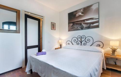 sypialnia z dużym białym łóżkiem w pokoju w obiekcie Appartamento al Forte di Talamonaccio w mieście Fonteblanda