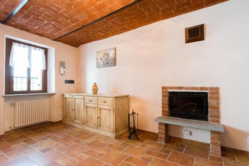 a living room with a fireplace and a window at Domus Amica in Lu