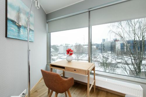 a room with a desk and a large window at Lootsi 3a Nordic Style with Parking in Tallinn
