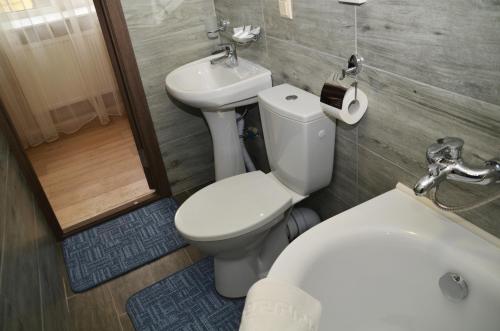 a bathroom with a toilet and a sink at Centralnyi hotel in Poltava
