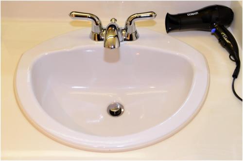 a sink with a faucet on a counter at The Hospitality Inn in Port Alberni