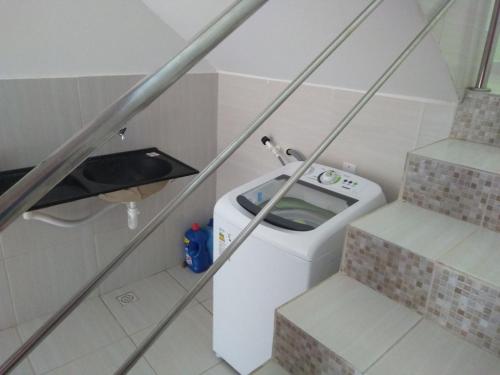 a small bathroom with a toilet and some stairs at Pousada beira rio in Baía da Traição