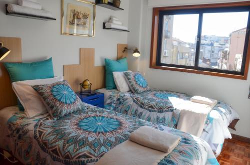 a bedroom with two beds and a window at PortoShelter in Porto