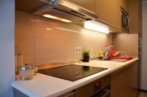 a kitchen with a sink and a counter top at PortoShelter in Porto