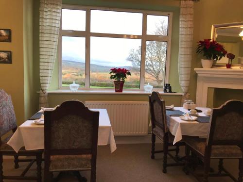 a dining room with a table and a window at Cedar House in Minehead
