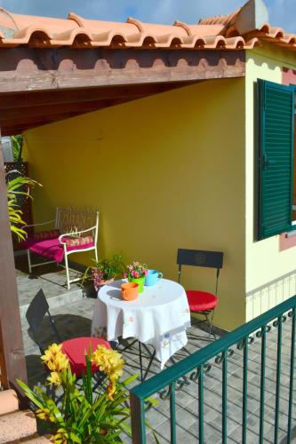 a patio with a table and chairs on a house at Bela Vista in Funchal