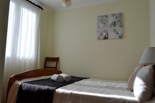 a bedroom with a bed with two towels on it at Bela Vista in Funchal