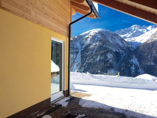 a room with a view of a snowy mountain at Chalet Magda-Lena in Heiligenblut