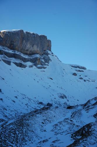a snow covered mountain with a cliff at Herzen´s Landhaus in Hirschegg