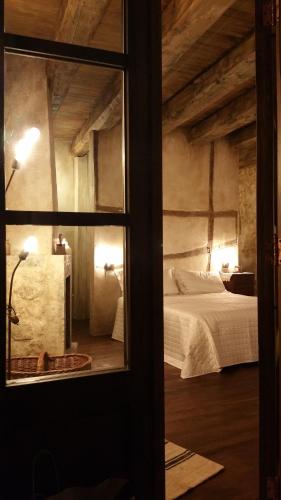 a view of a bedroom with a bed and a window at Charme in Perillis in Popoli