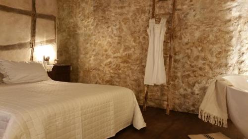 a dress hanging on a wall next to a bed at Charme in Perillis in Popoli