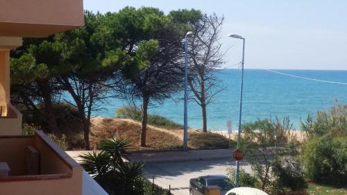 a view of the ocean from a balcony of a house at Sicilia Mare Apartments in San Leone