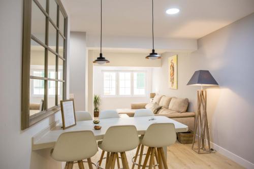 a living room with a white table and chairs at Picasso Premium in Málaga