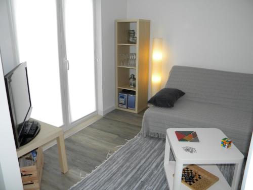 a bedroom with a bed and a tv and a table at Serra da Pescaria House - Nazaré in Nazaré