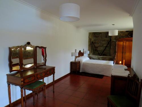 蓬蒂達巴爾卡的住宿－Quinta do Coto Moinho，一间卧室配有一张床、梳妆台和书桌