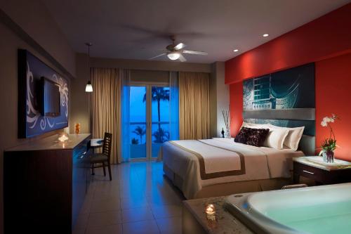 a hotel room with a bed and a bath tub at Hard Rock Hotel Vallarta All Inclusive in Nuevo Vallarta 