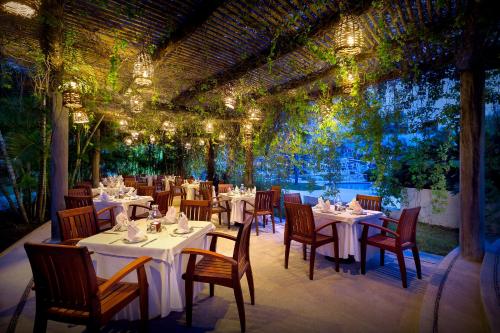 a restaurant with white tables and chairs and lights at Hard Rock Hotel Vallarta All Inclusive in Nuevo Vallarta 