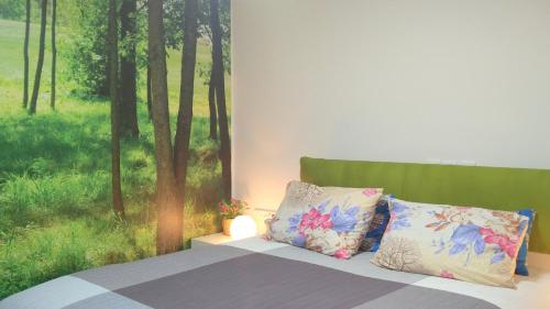 a bedroom with a bed and a window with trees at Like Home Gedera in Gedera