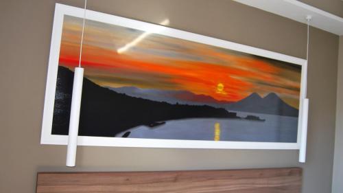a painting hanging on a wall in a room at 7th Floor Suite in Naples
