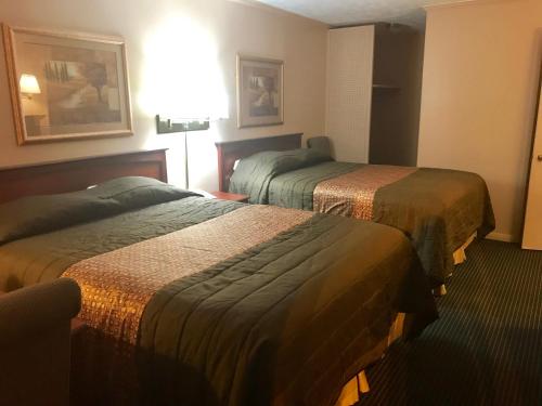 a hotel room with two beds in a room at Redwood Inn in Gadsden