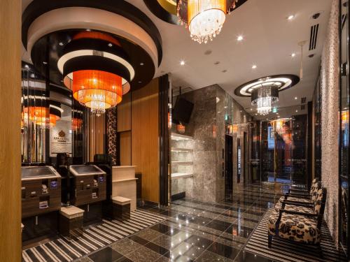 a lobby with chandeliers and a hair salon at APA Hotel Kanda Ekimae in Tokyo