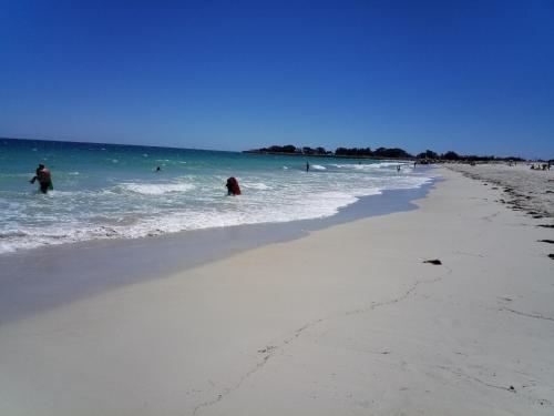 a group of people in the water at the beach at Sorrento Beach Bed & Breakfast in Perth
