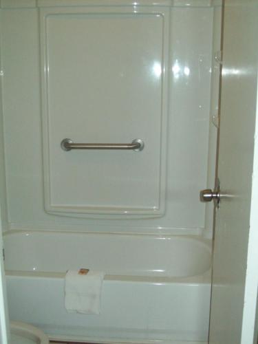 a bathroom with a white tub and a toilet at Relax Inn Savannah in Savannah