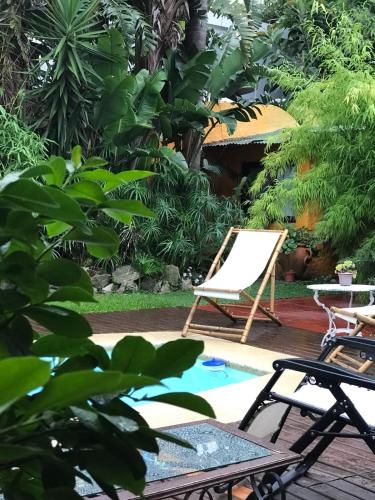a patio with a chair and a pool at Casa Bambu, alquiler de corta estadia in Ciudad de la Costa