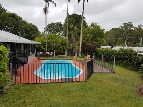 a fence around a swimming pool in a yard at Beerwah House in Beerwah