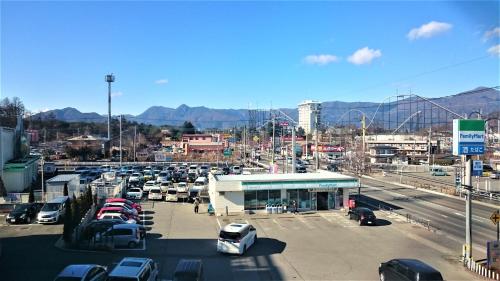 a parking lot with cars parked in a parking lot at West Inn Fuji-Yoshida in Fujiyoshida