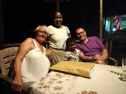 a family posing for a picture at a table at Mahi Villa in Bentota