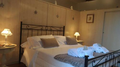a bedroom with a bed with towels on it at DENEB 19 Apartment in Verona