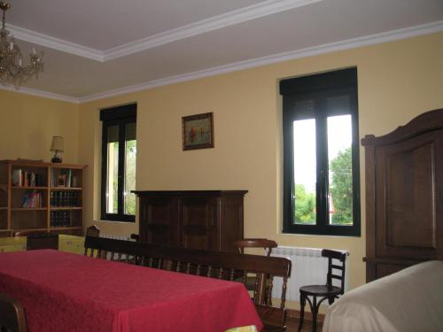 a bedroom with a bed and two windows at Dama del Alba in Vega de Magaz