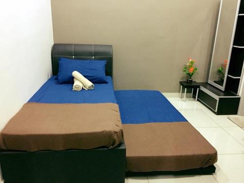 a bed with two pillows on it in a bedroom at Bukit Banyan Homestay Sungai Petani in Sungai Petani