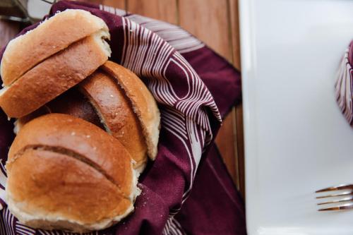 a plate with two buns on a napkin at Hemingways Retreat Kigali in Kigali