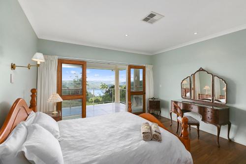 a bedroom with a bed and a desk and a piano at Lemon Grove in Montville