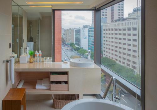 a bathroom with a sink and a large window at Hotel COZZI Minsheng Taipei in Taipei
