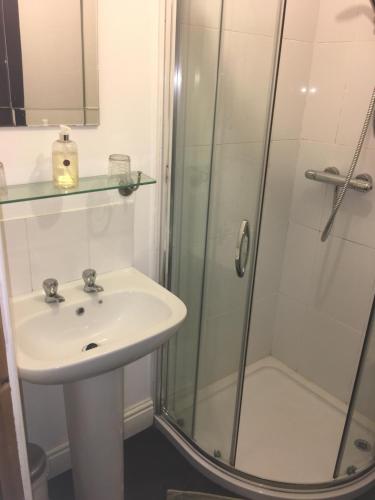 a bathroom with a sink and a shower at Stone Cottage in Ponteland