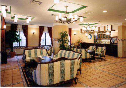 a living room with couches and a table in a room at Hyuga Dai-ichi Hotel in Hyuga