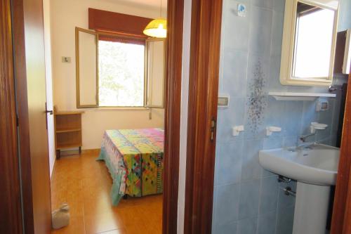 a bathroom with a sink and a bed in a room at Villetta Patitari in Gallipoli