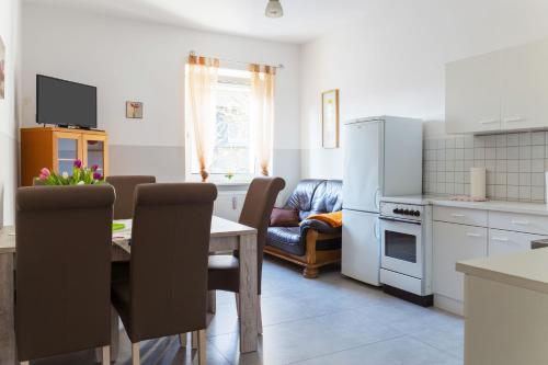 a kitchen with a table and a dining room at Ferienwohnung in Witten