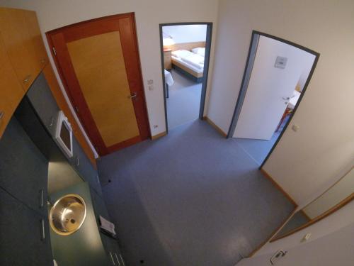 an overhead view of a hallway with a staircase and a door at Haus Mobene - Hotel Garni in Graz