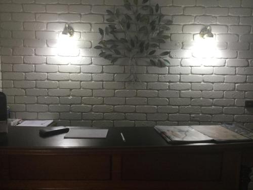 a desk with two lights on a white brick wall at Albury Townhouse Motel in Albury