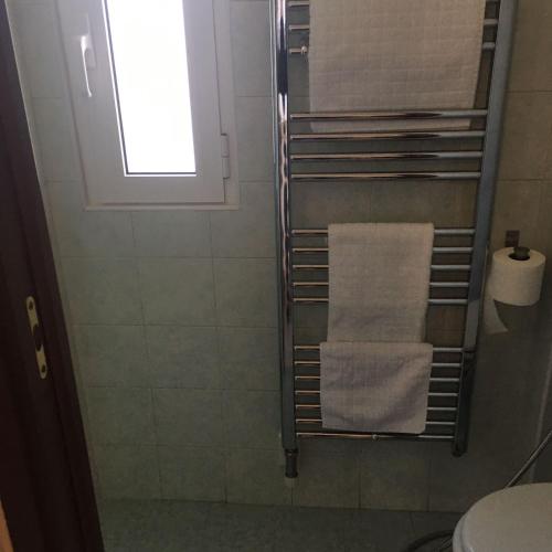 a bathroom with a towel rack and a toilet at Parea House 2 in Milan