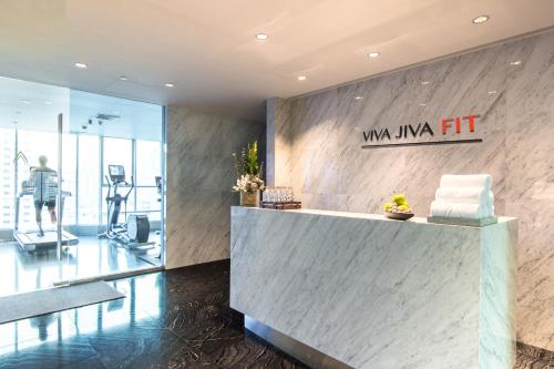a lobby of a gym with a reception desk at Lancaster Bangkok in Bangkok