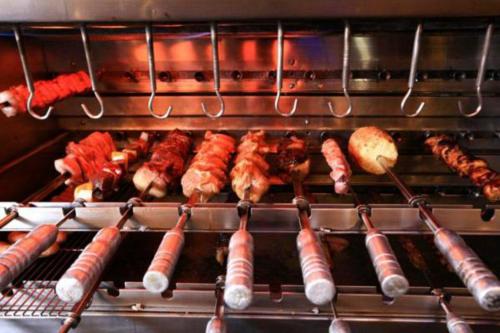 a bunch of different types of food cooking in an oven at V-Continent Beijing Parkview Wuzhou Hotel in Beijing